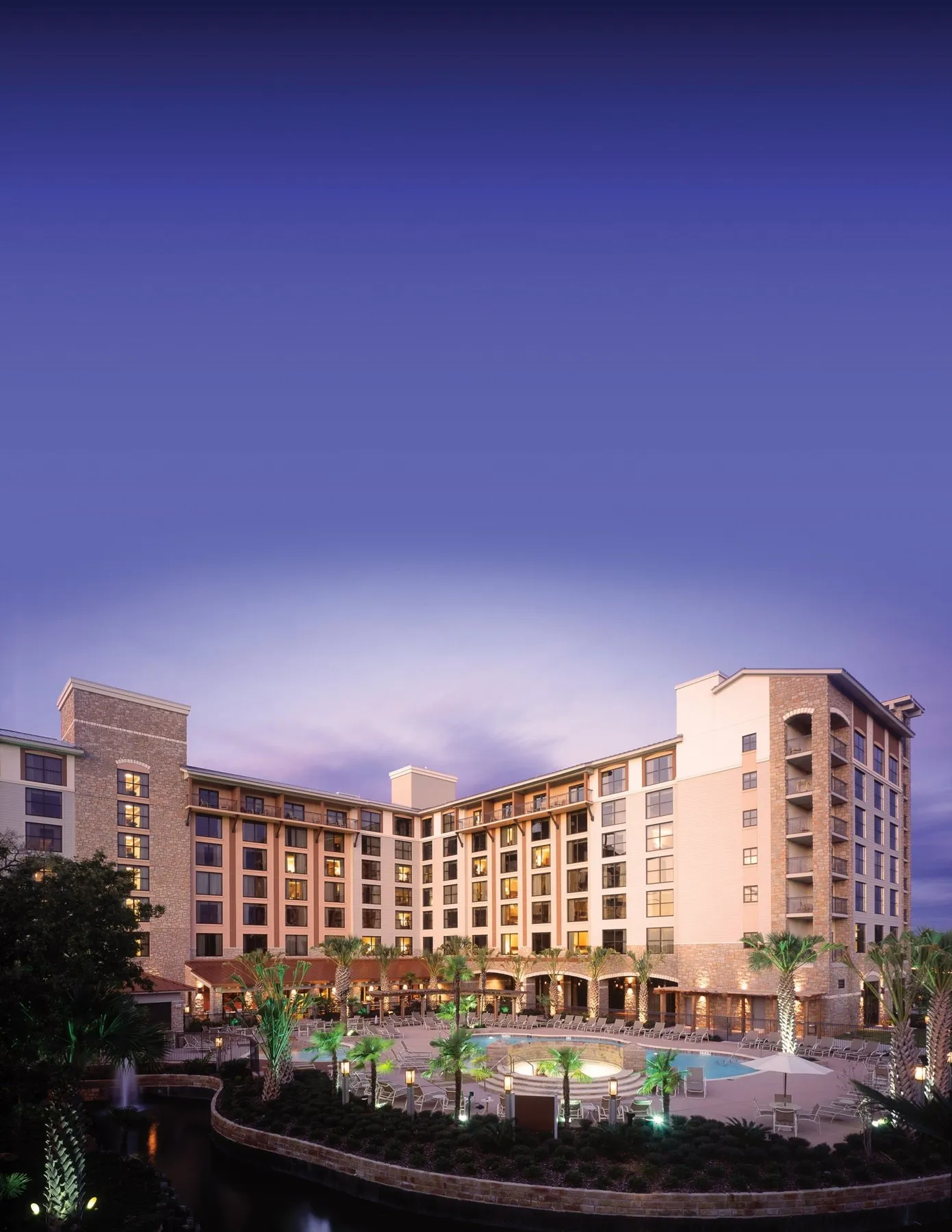 Hotel tower and pool at Horseshoe Bay Resort at dusk