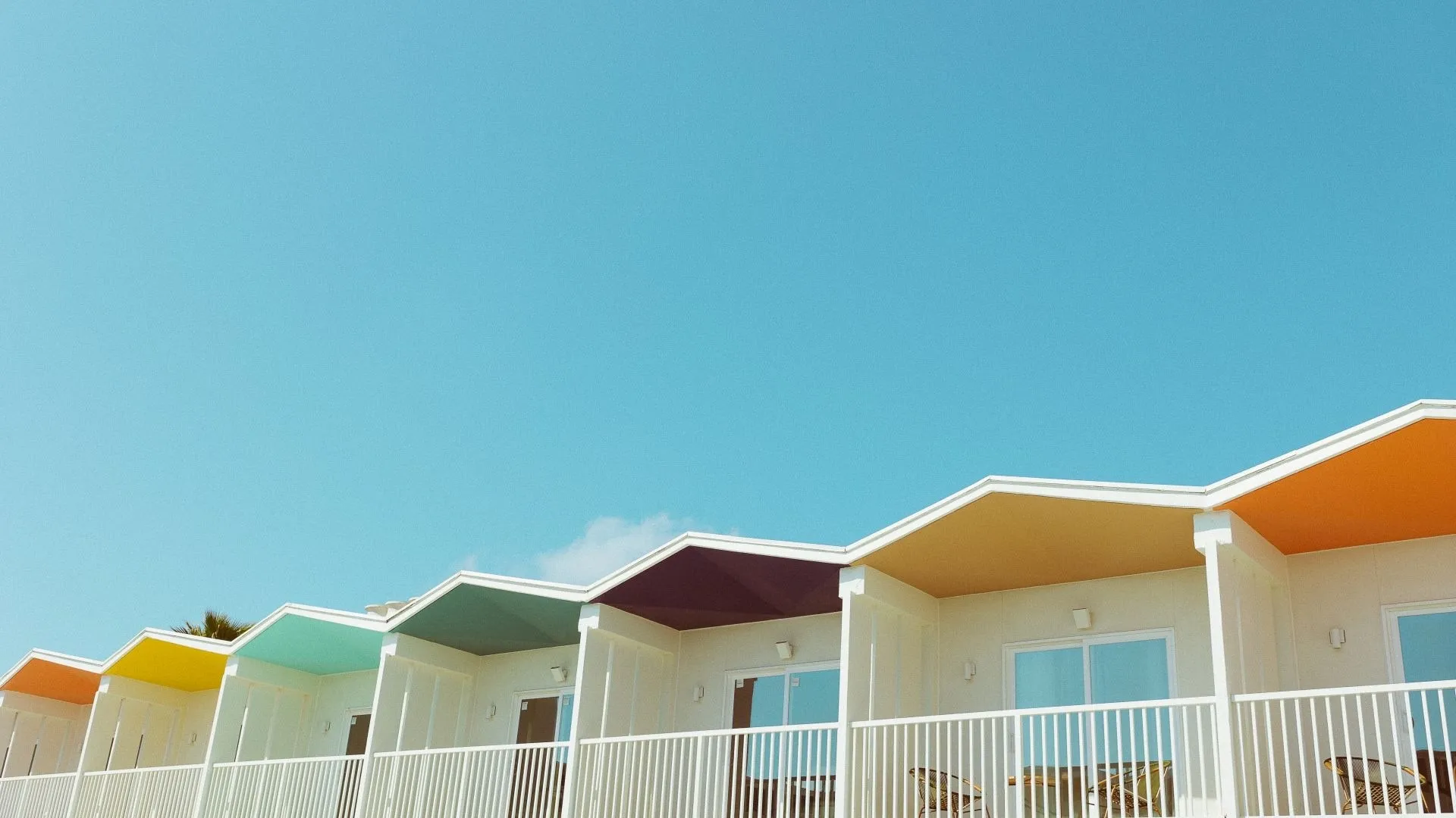 Colorful upper-floor balconies at Hotel Lucine in Galveston