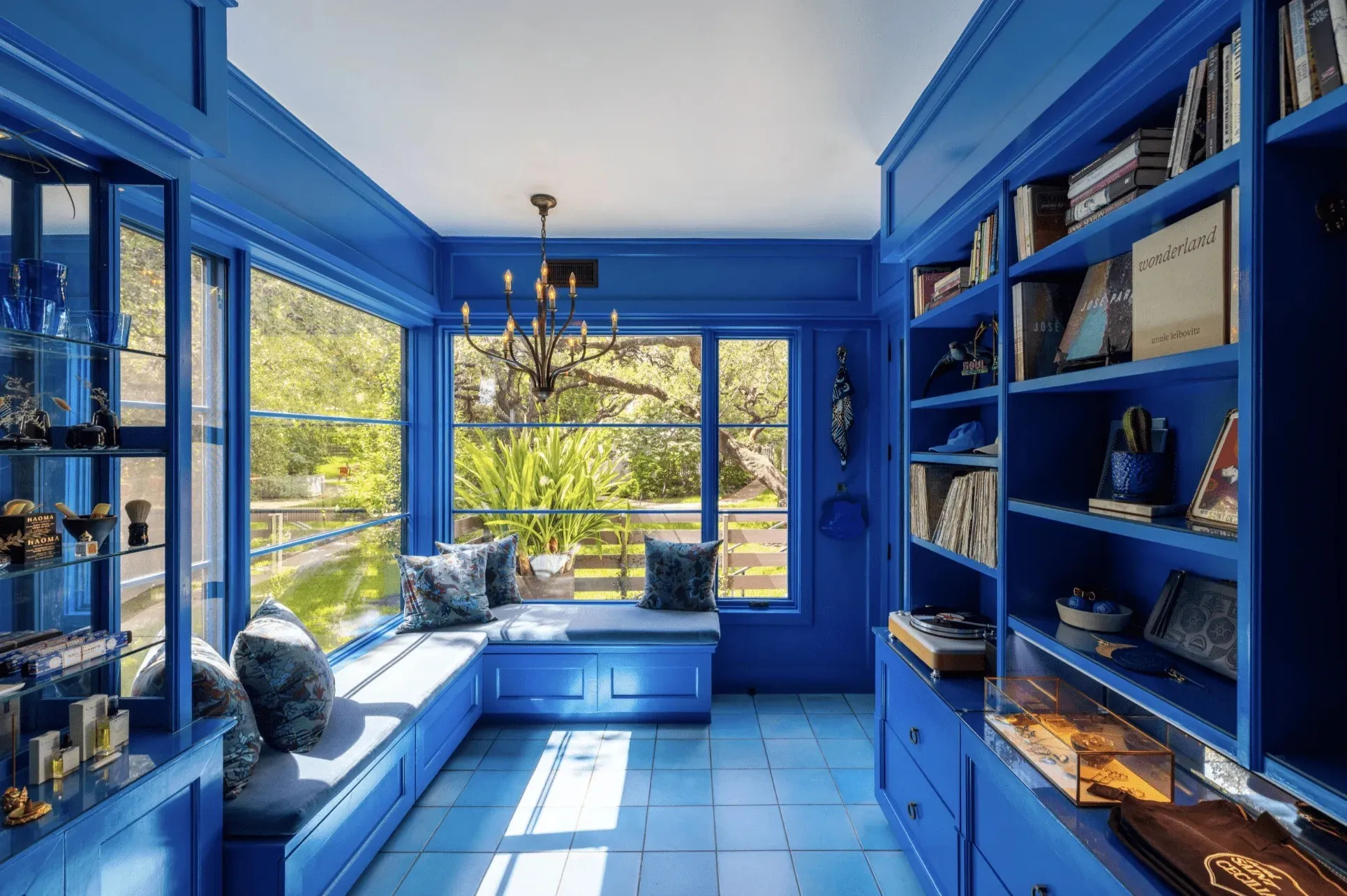 Blue walls and bookshelves in a Hotel Saint Cecilia lounge