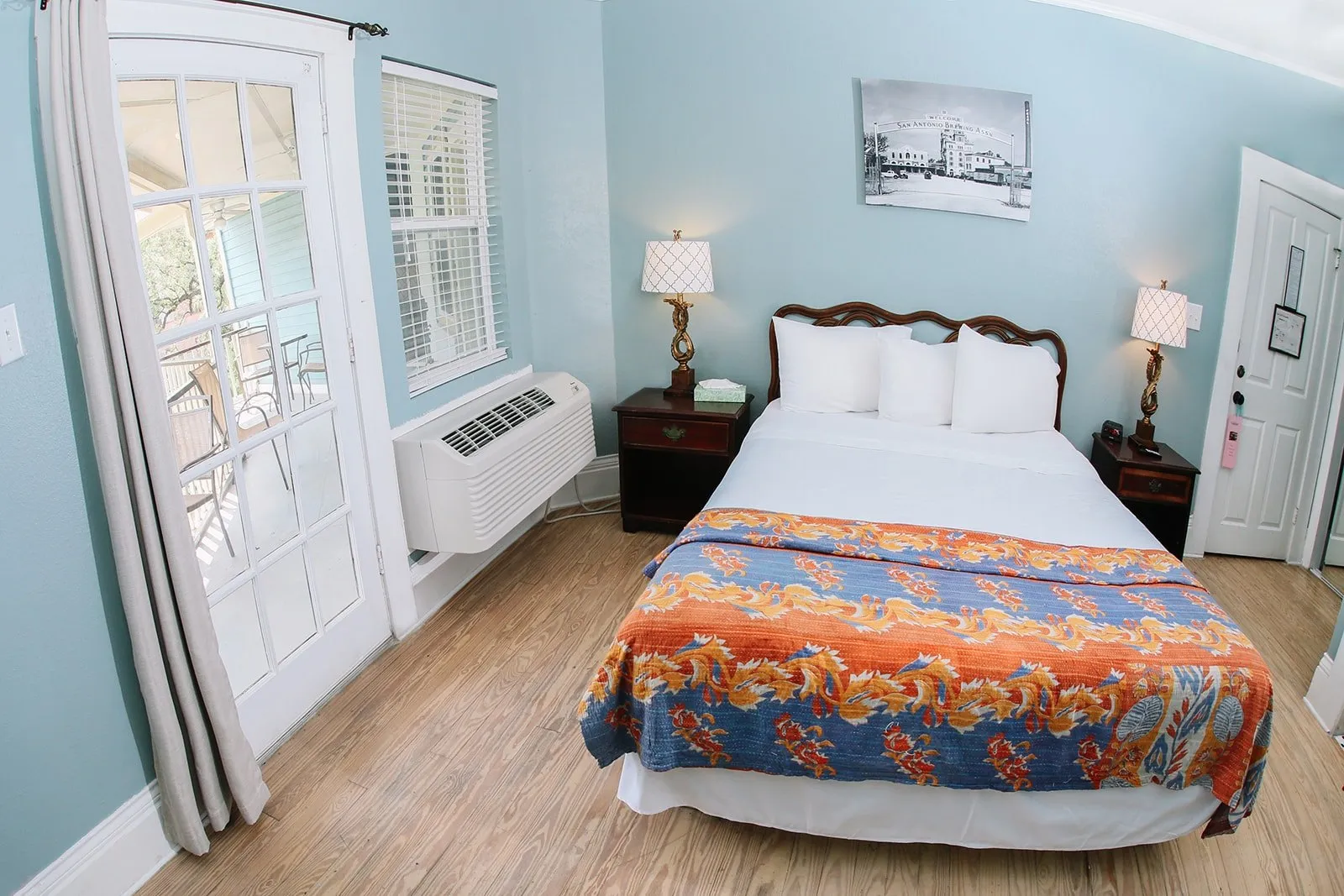Queen bed and pale blue walls in the Pearl Suite at Inn on the Riverwalk