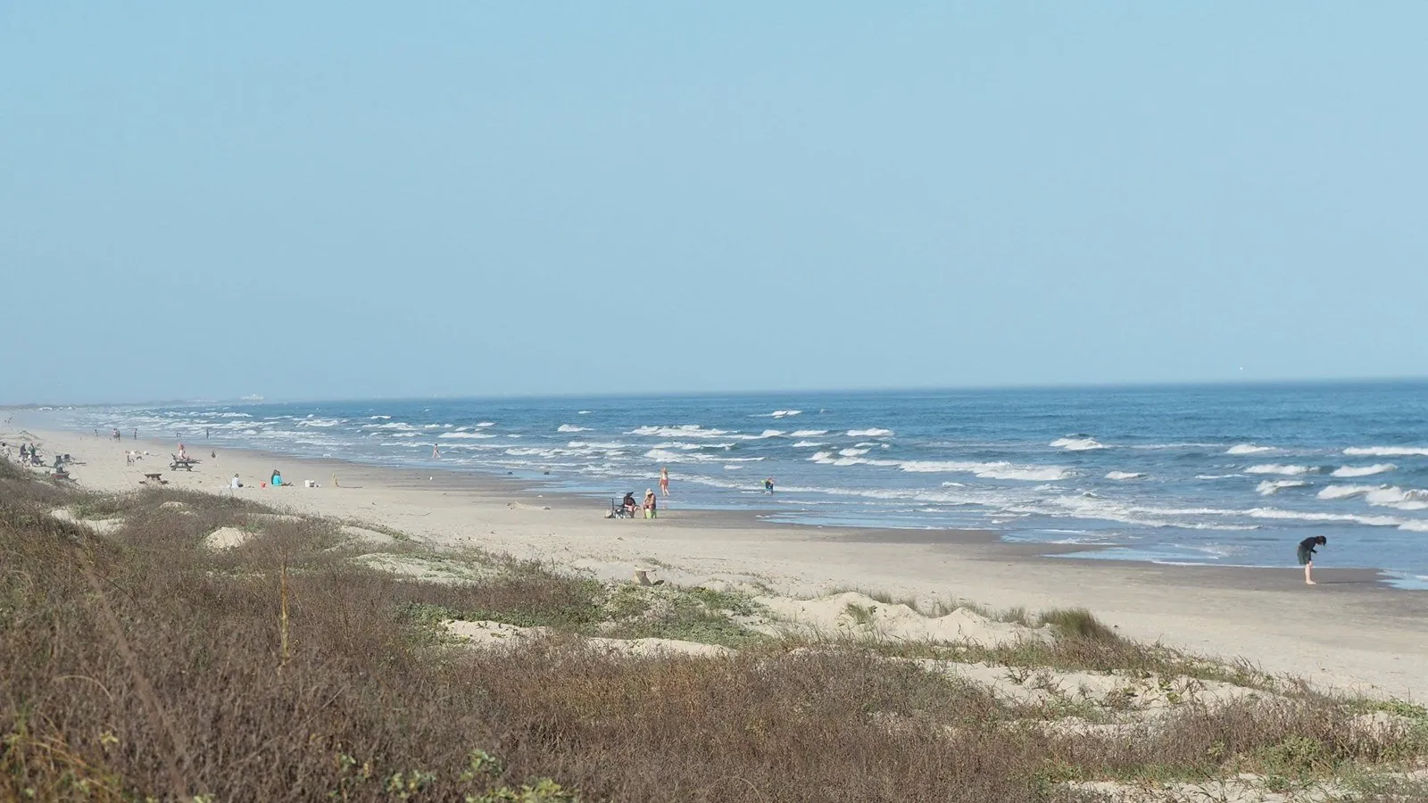 Dunes and beachgoers beside the Gulf at Malaquite Beach