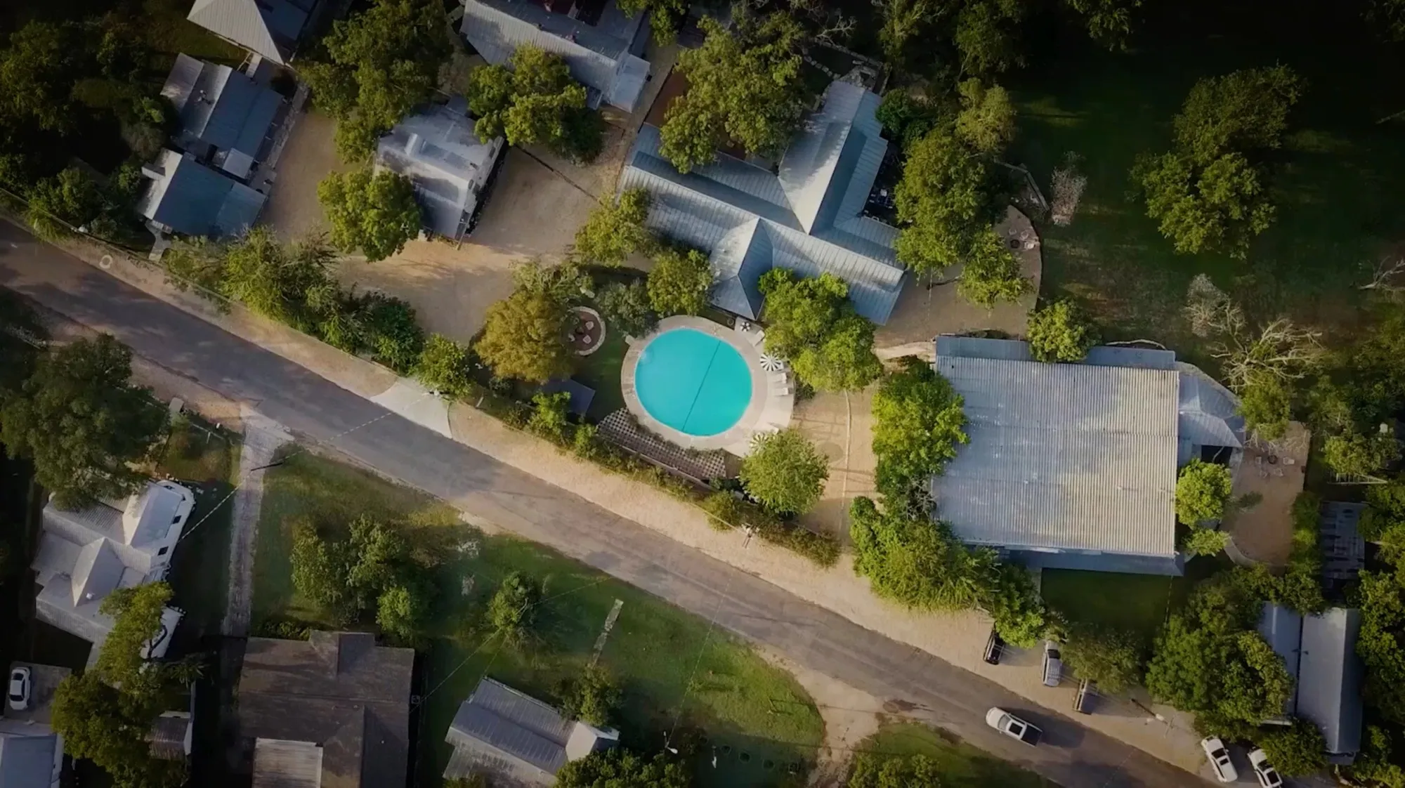 Aerial view of a pool and historic buildings at The Meyer Hotel