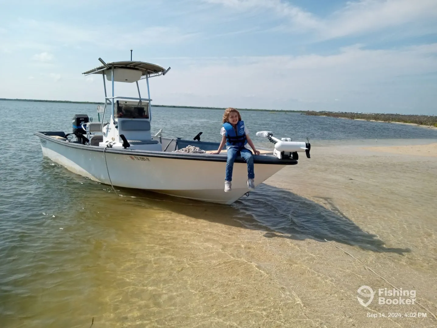 A Family Fishing Charters boat in shallow water