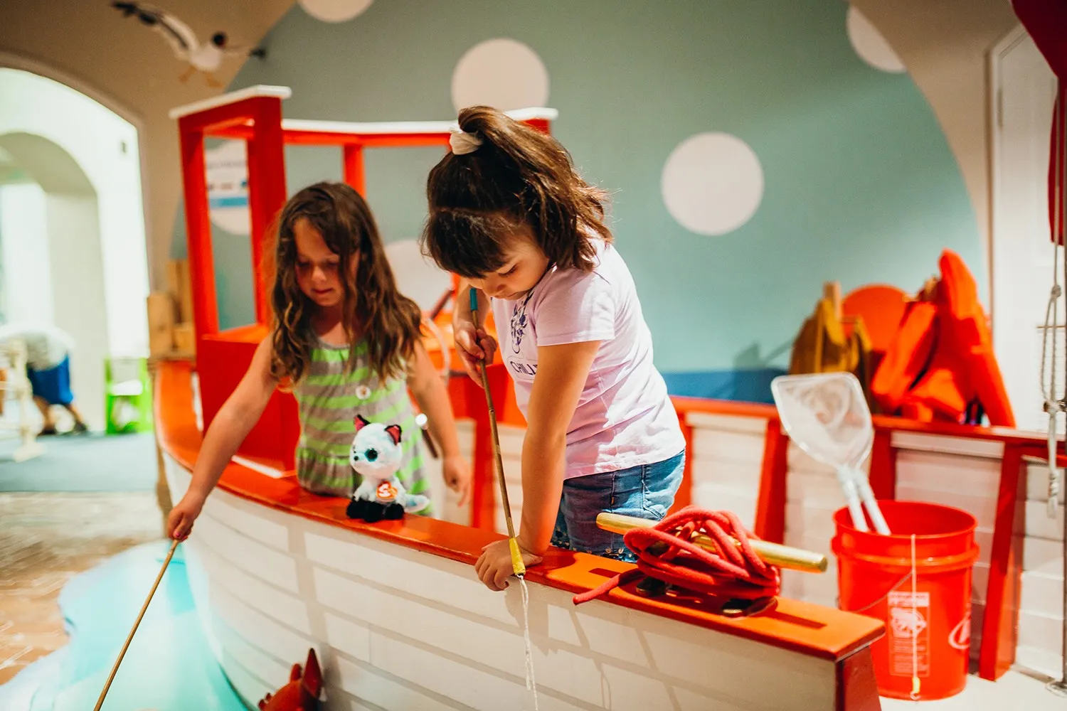 Children playing in the boat exhibit at Galveston Children's Museum