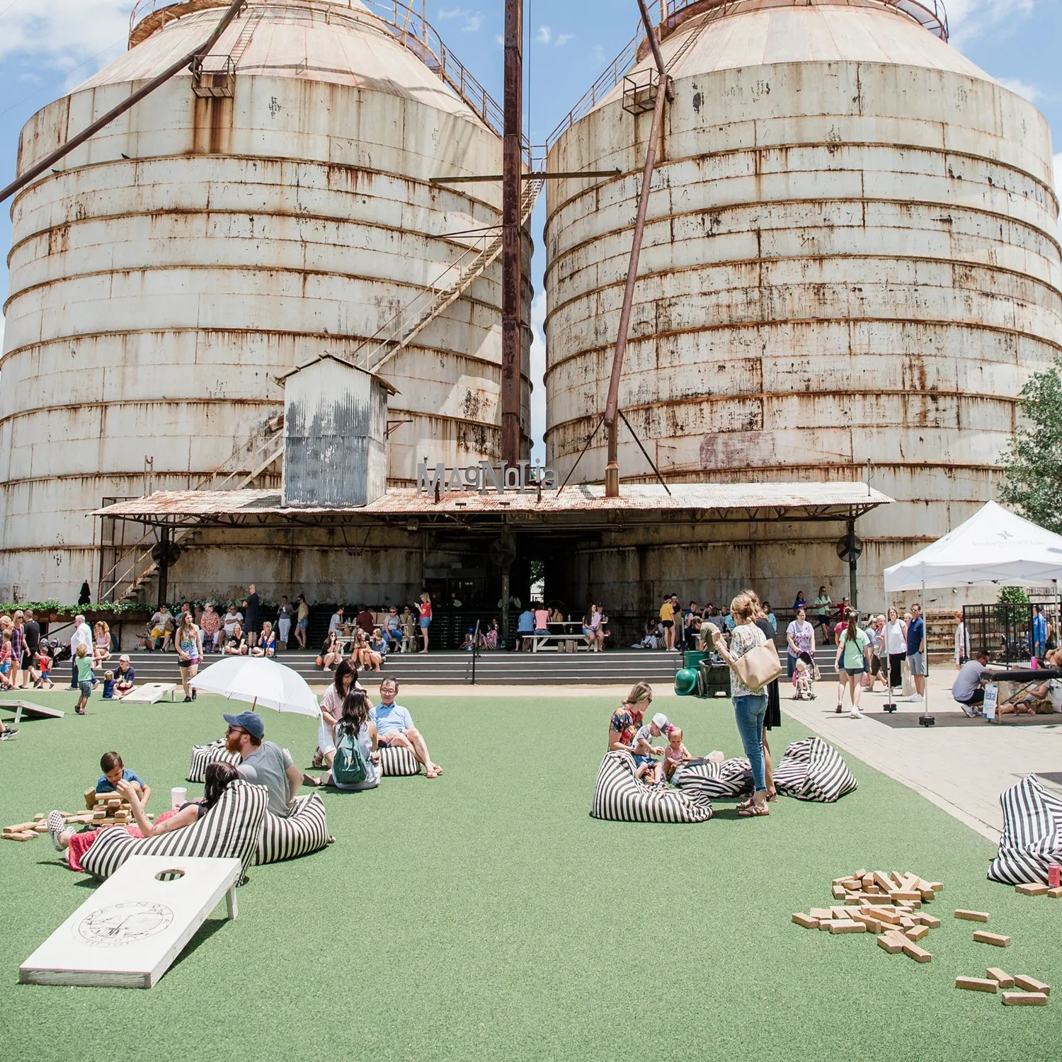 Visitors on the lawn beneath the Magnolia Market silos