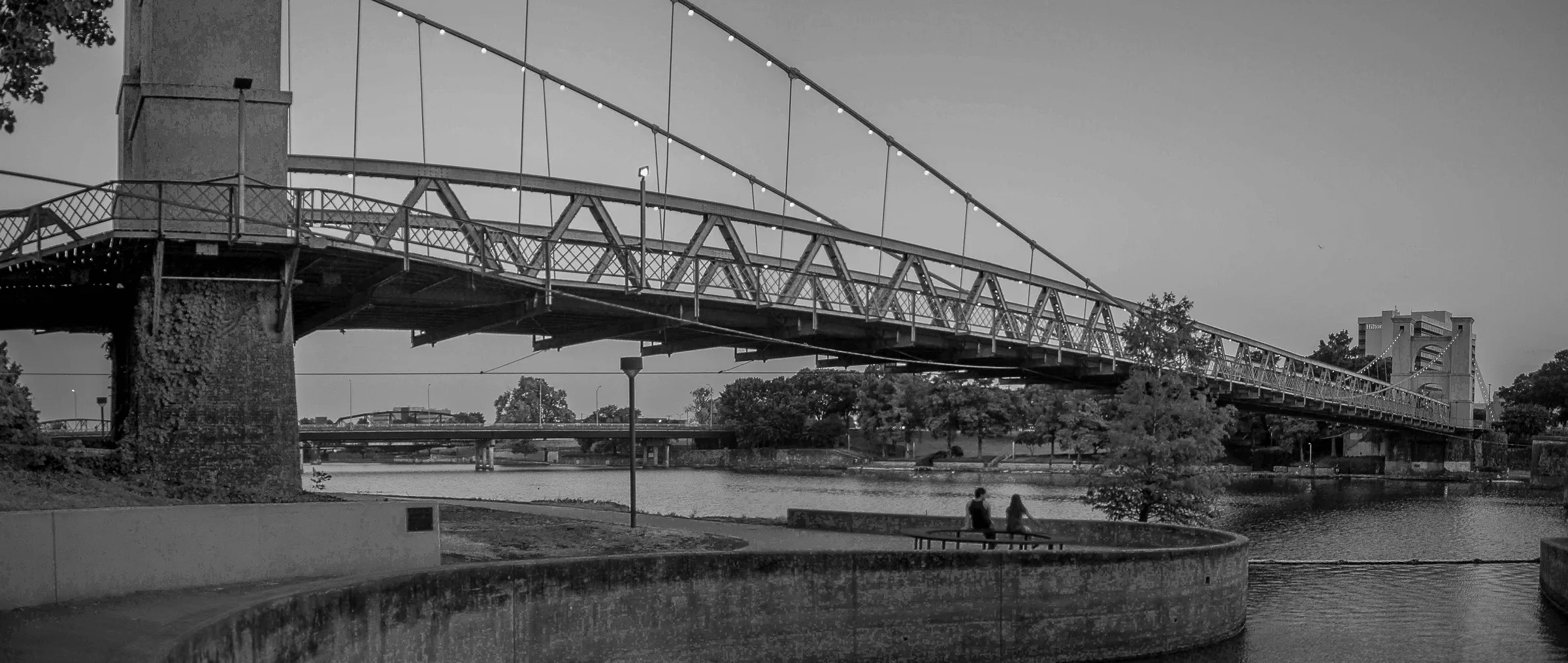 A black-and-white view of the Waco Suspension Bridge over the Brazos River