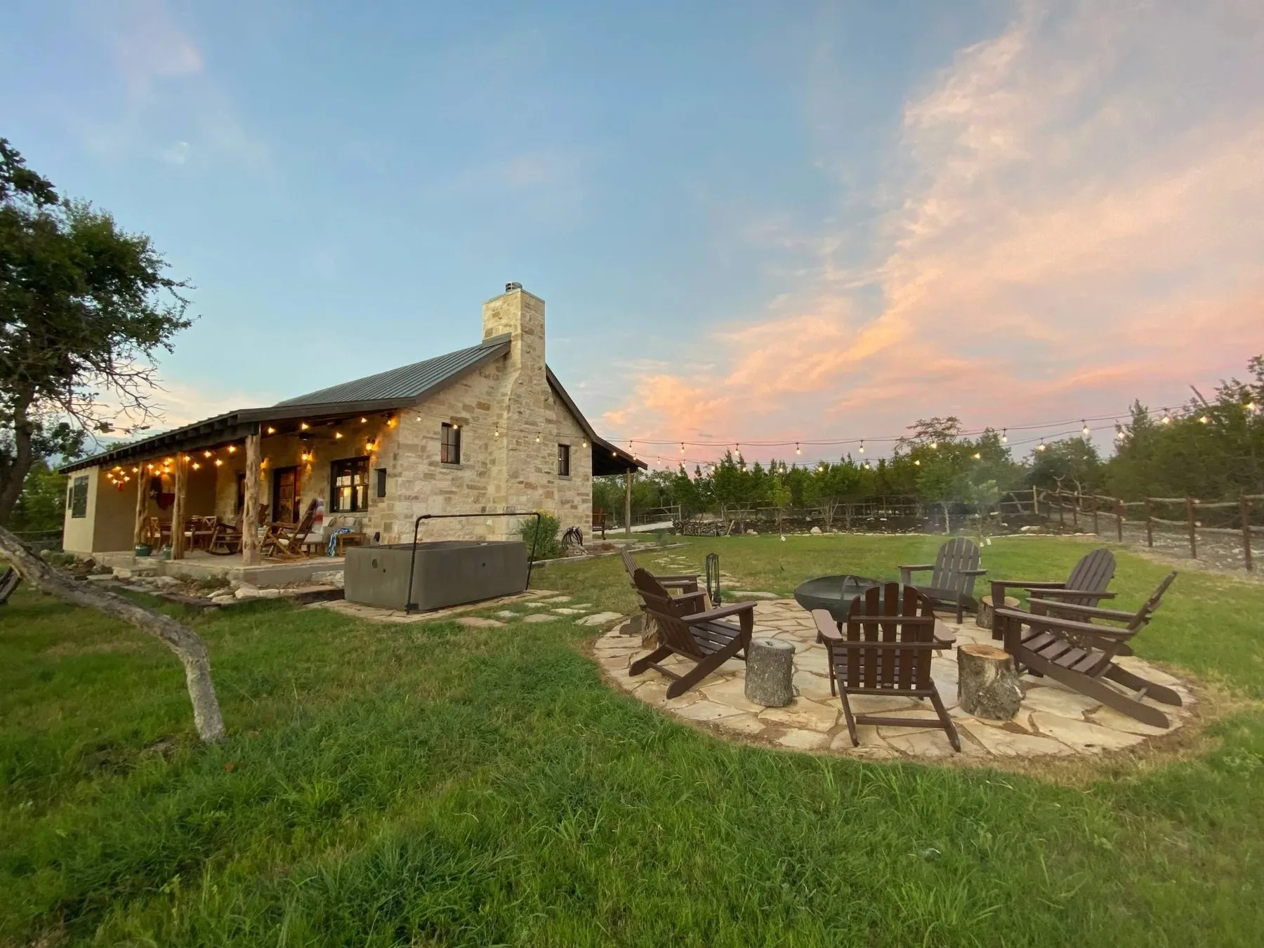 A stone cabin and outdoor chairs at The Outpost