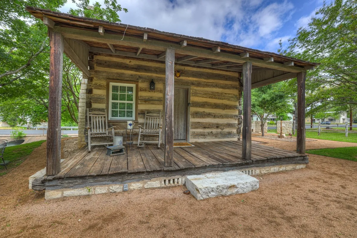 The log walls and covered porch of Town Creek Cabin