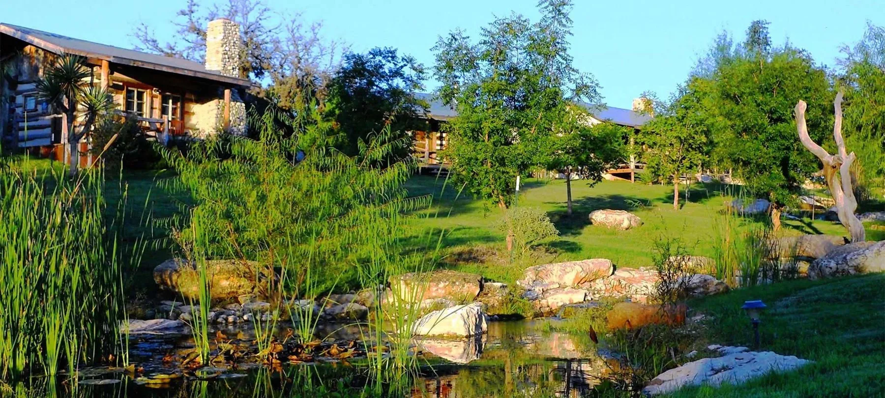 Cabins and landscaped pond at Barons CreekSide