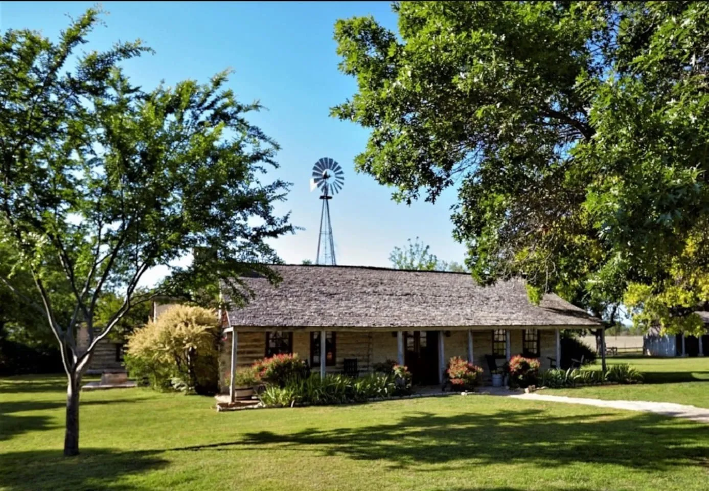 A historic stone house among trees at Settlers Crossing