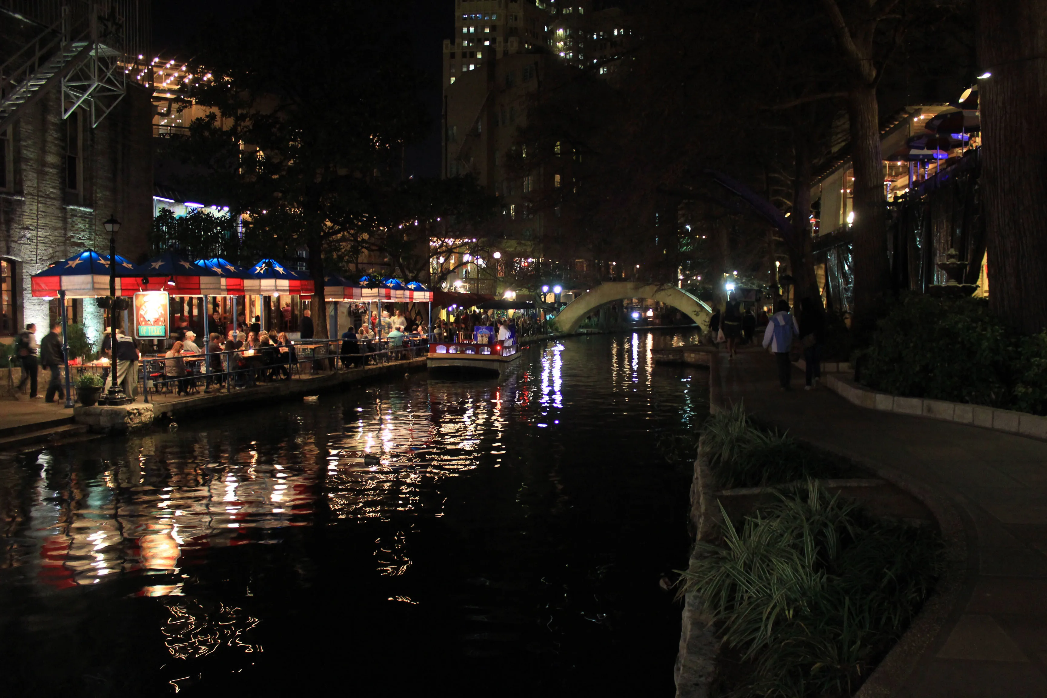 Lights reflected in the San Antonio River Walk at night