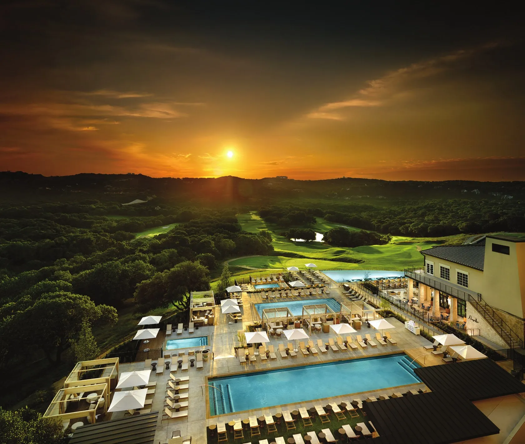 Sunset over the pools and golf course at Omni Barton Creek Resort and Spa