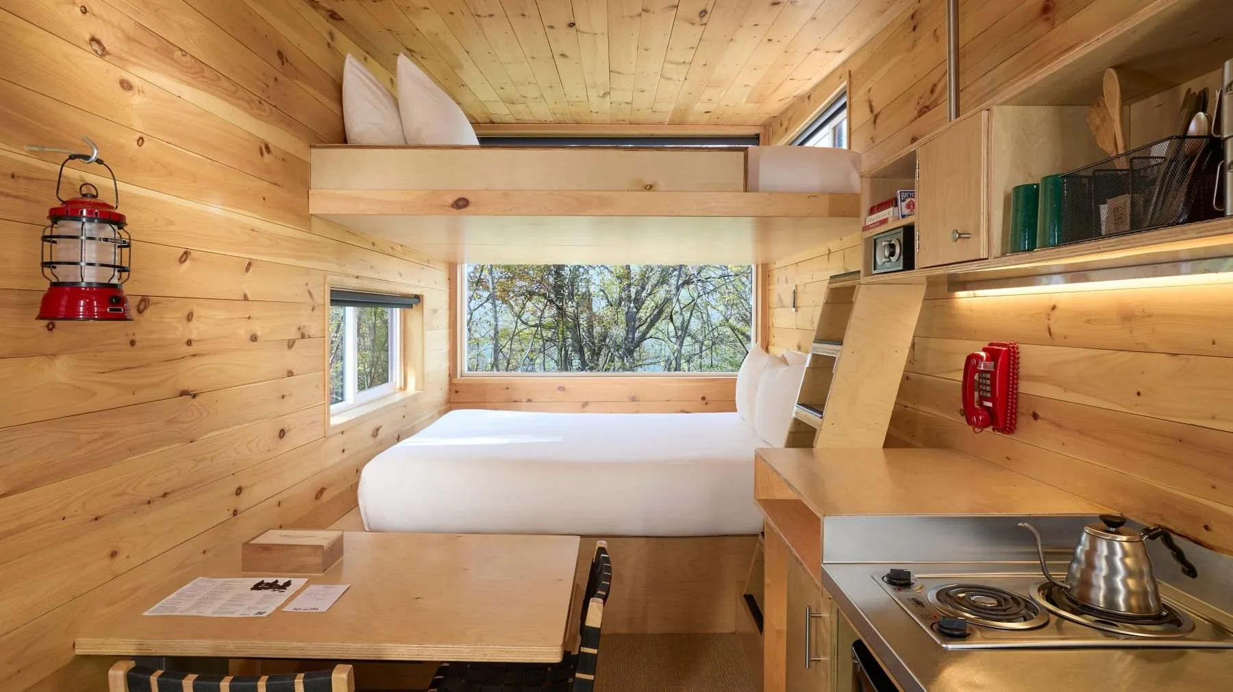 Stacked beds and a kitchenette in a Postcard Cabins Hill Country cabin