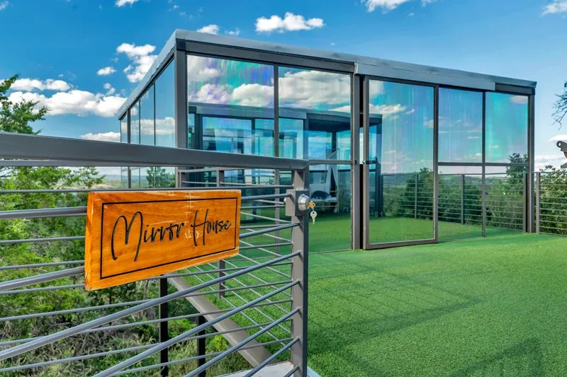 Reflective glass walls and a deck at Retreat Ranch's Mirror House
