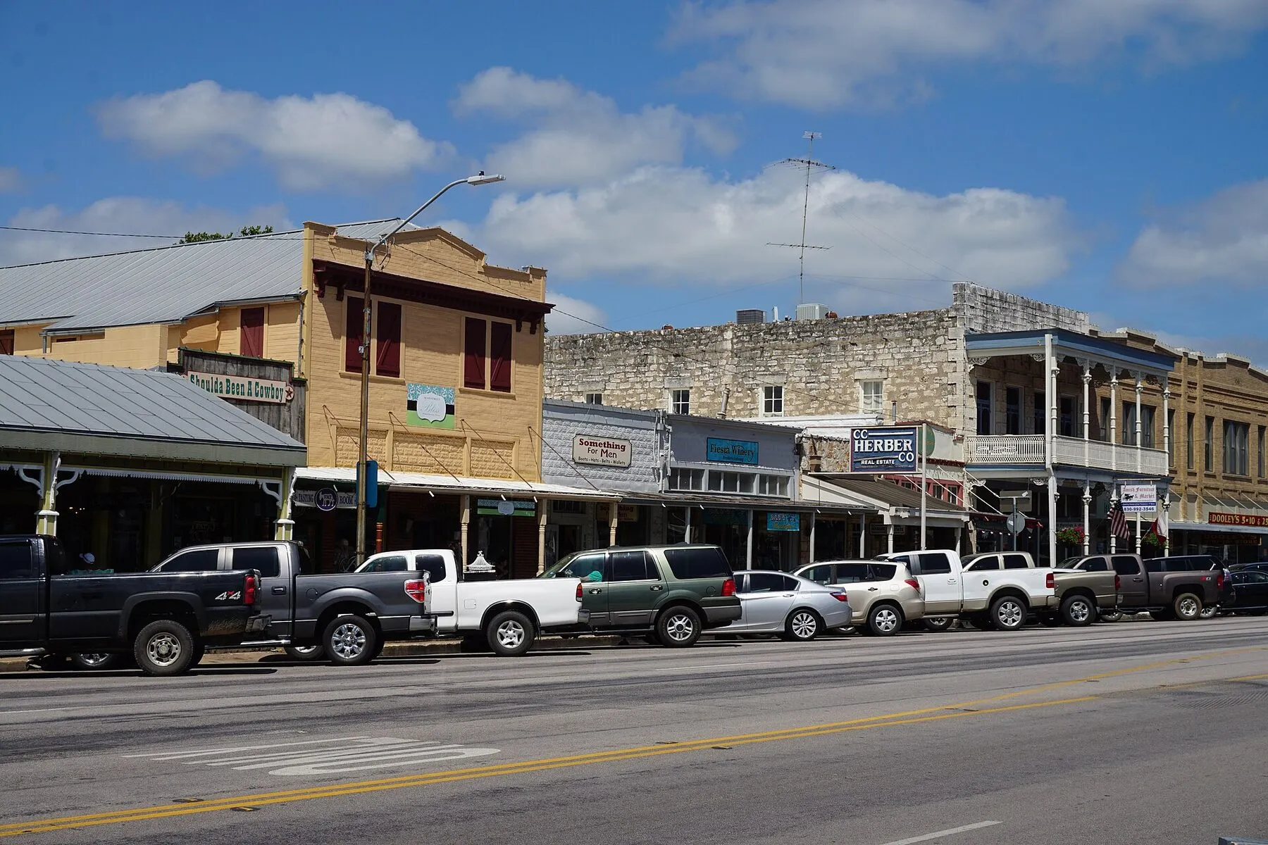 Historic storefronts and parked cars along East Main Street in Fredericksburg