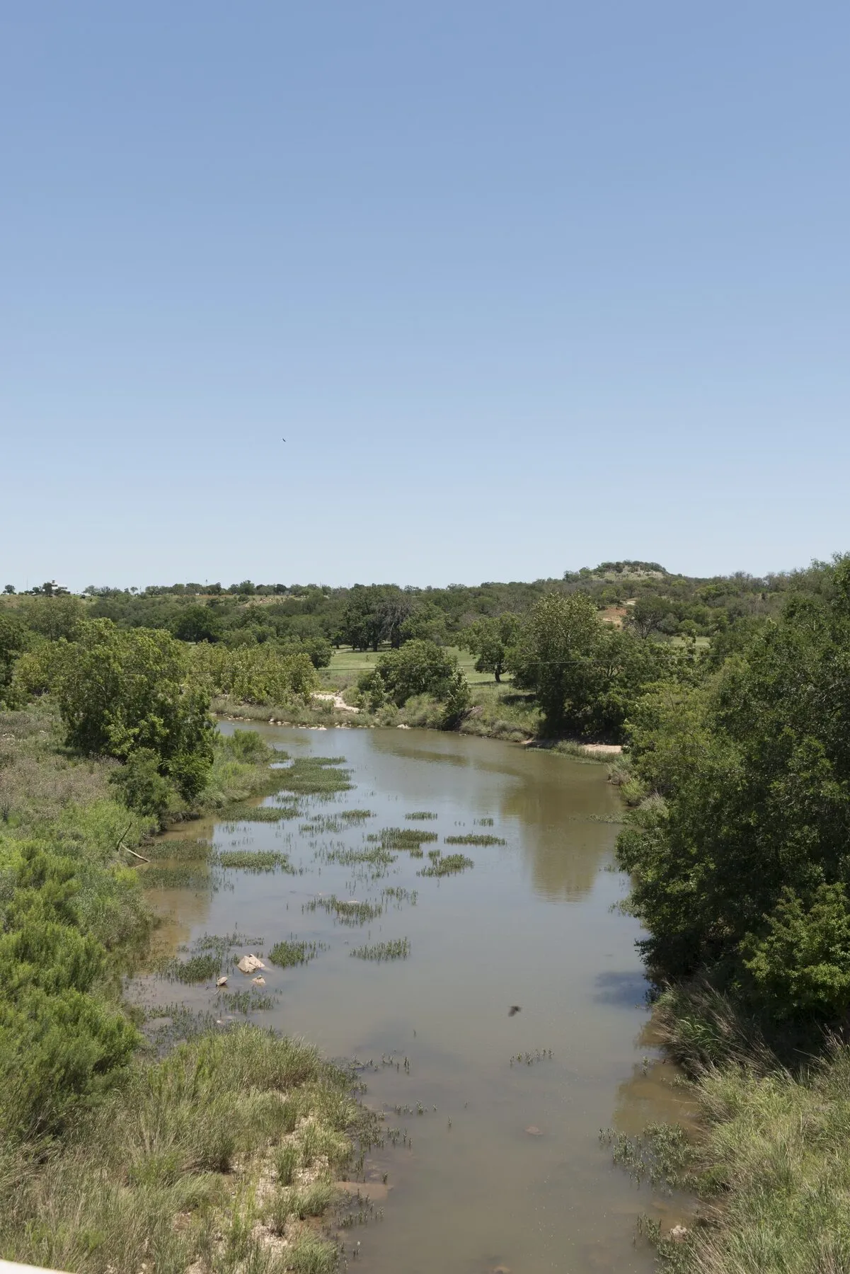 Pedernales River winding between rocky, tree-covered Hill Country banks