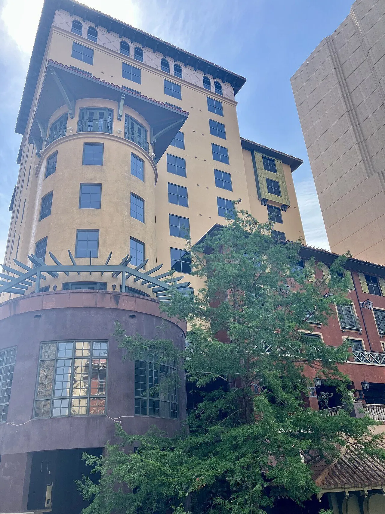 The stone and stucco exterior of Hotel Valencia Riverwalk on East Houston Street