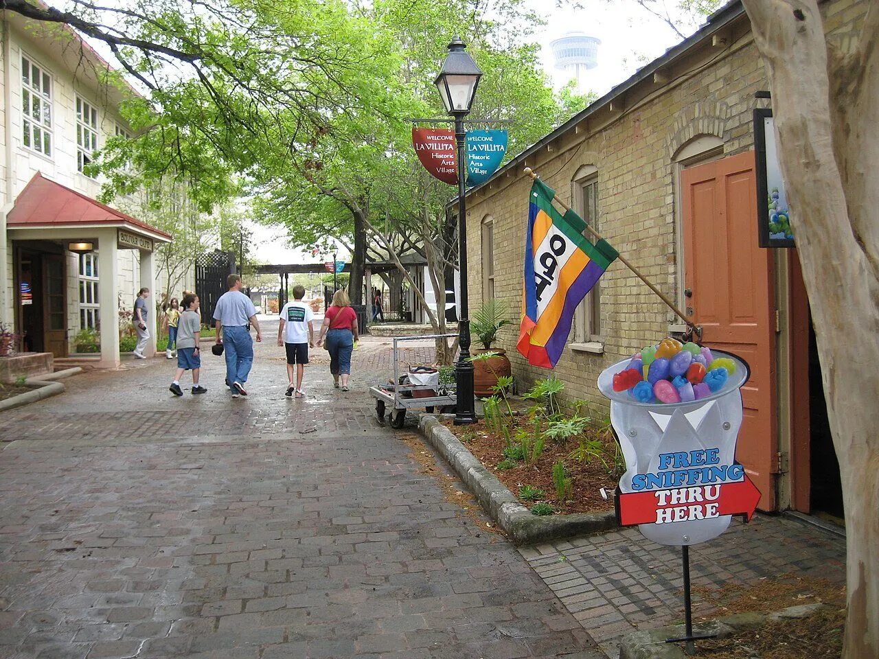 A brick lane lined with small historic buildings and trees in La Villita
