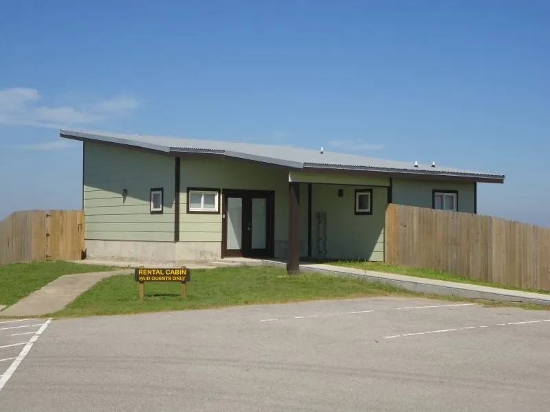Sea Rim State Park cabin beside a paved parking space