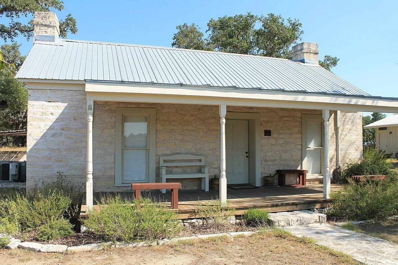 Historic limestone house with a front porch in Wimberley