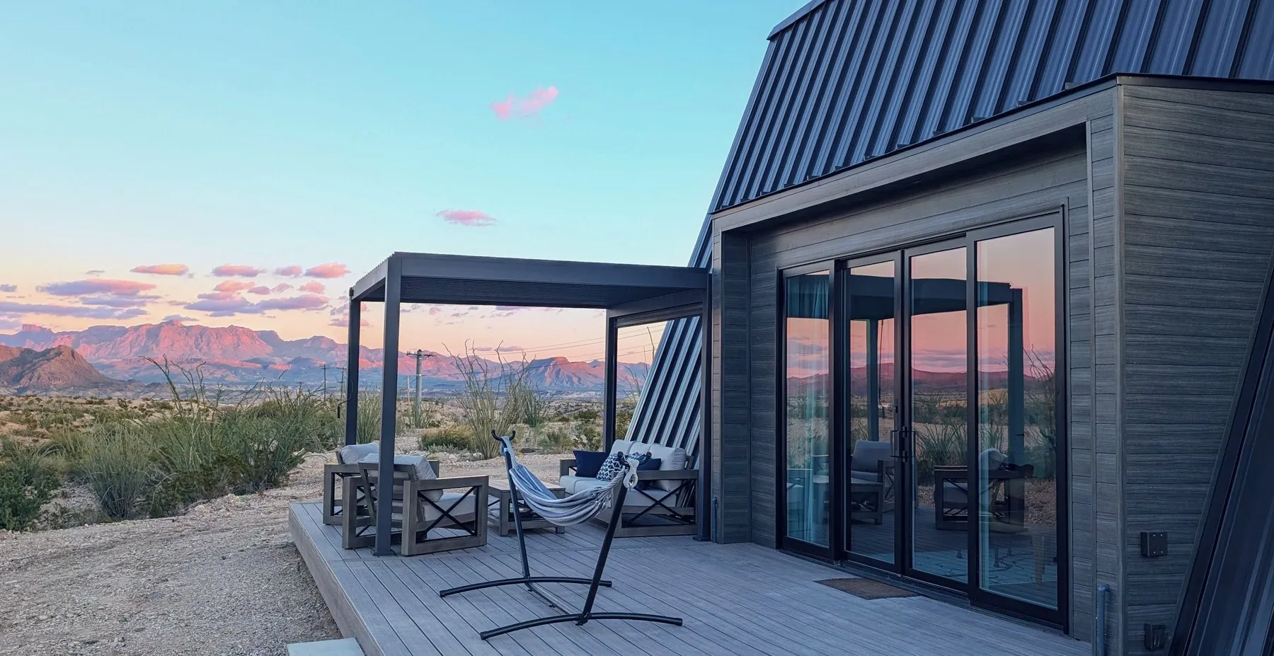Deck outside an A-frame cabin at Stardust Big Bend