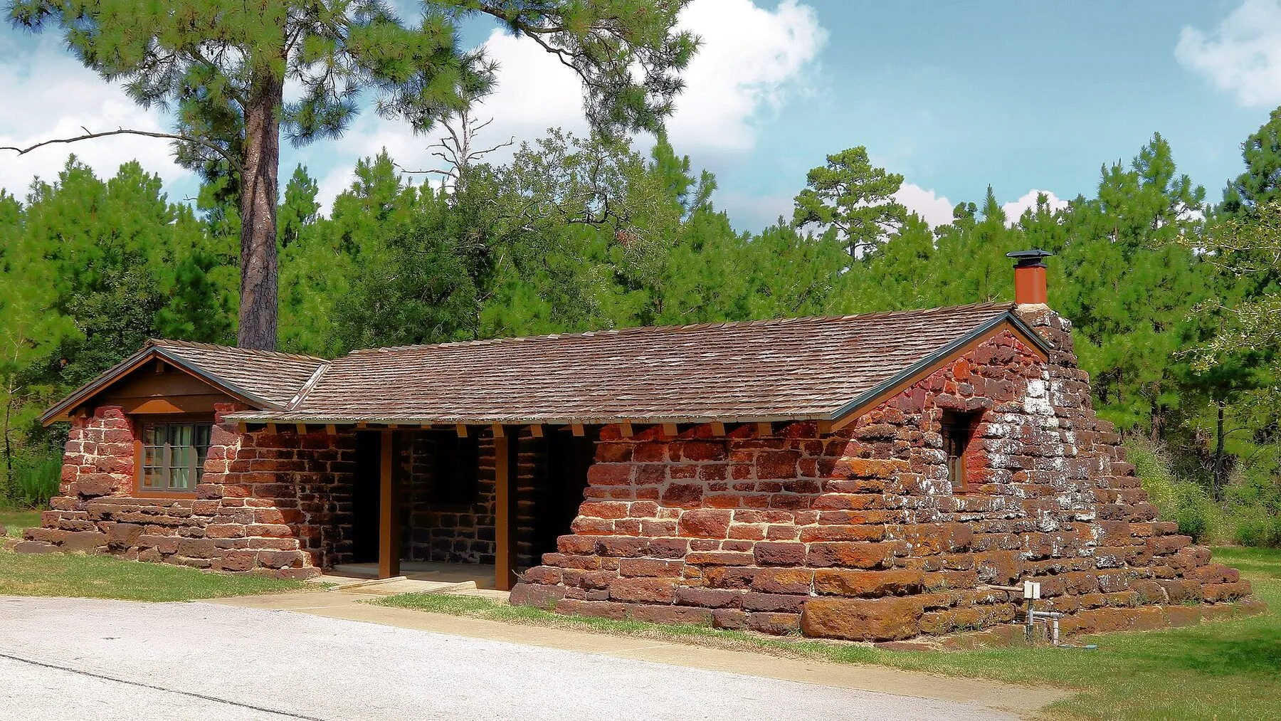 Stone Cabin 14 beneath trees at Bastrop State Park