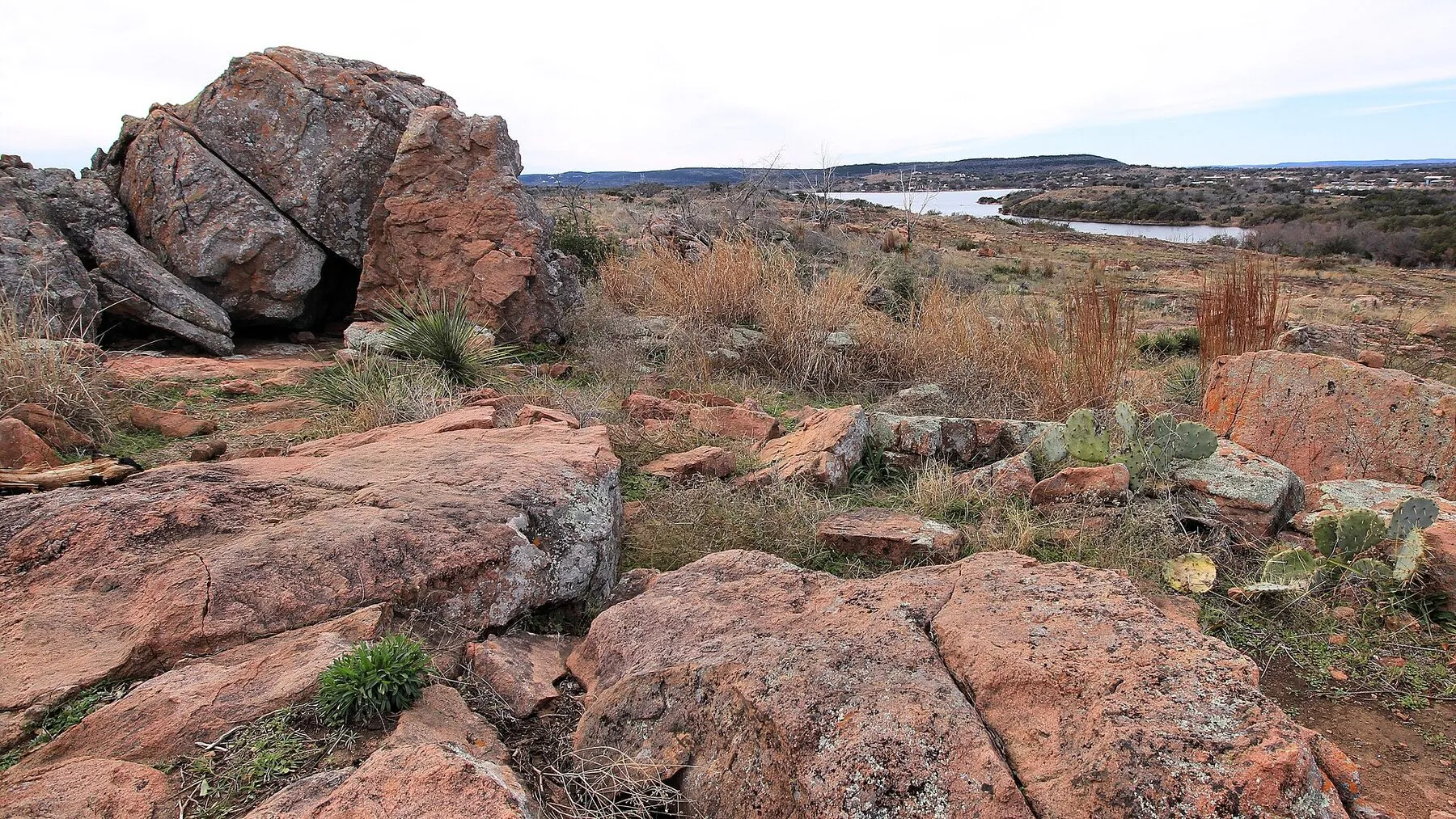 Inks Lake seen from a pink-granite overlook beneath a blue sky