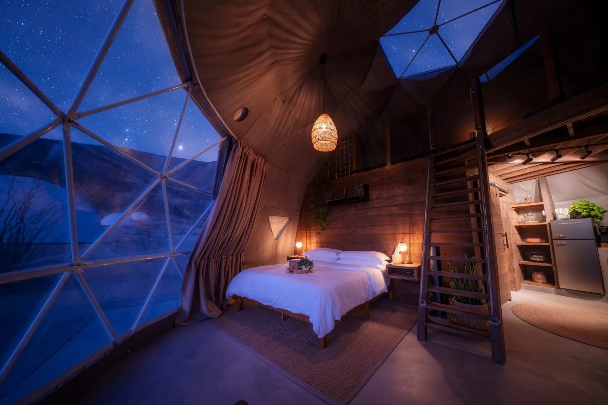 Bed and stairs beneath a dome roof at The Summit at Big Bend