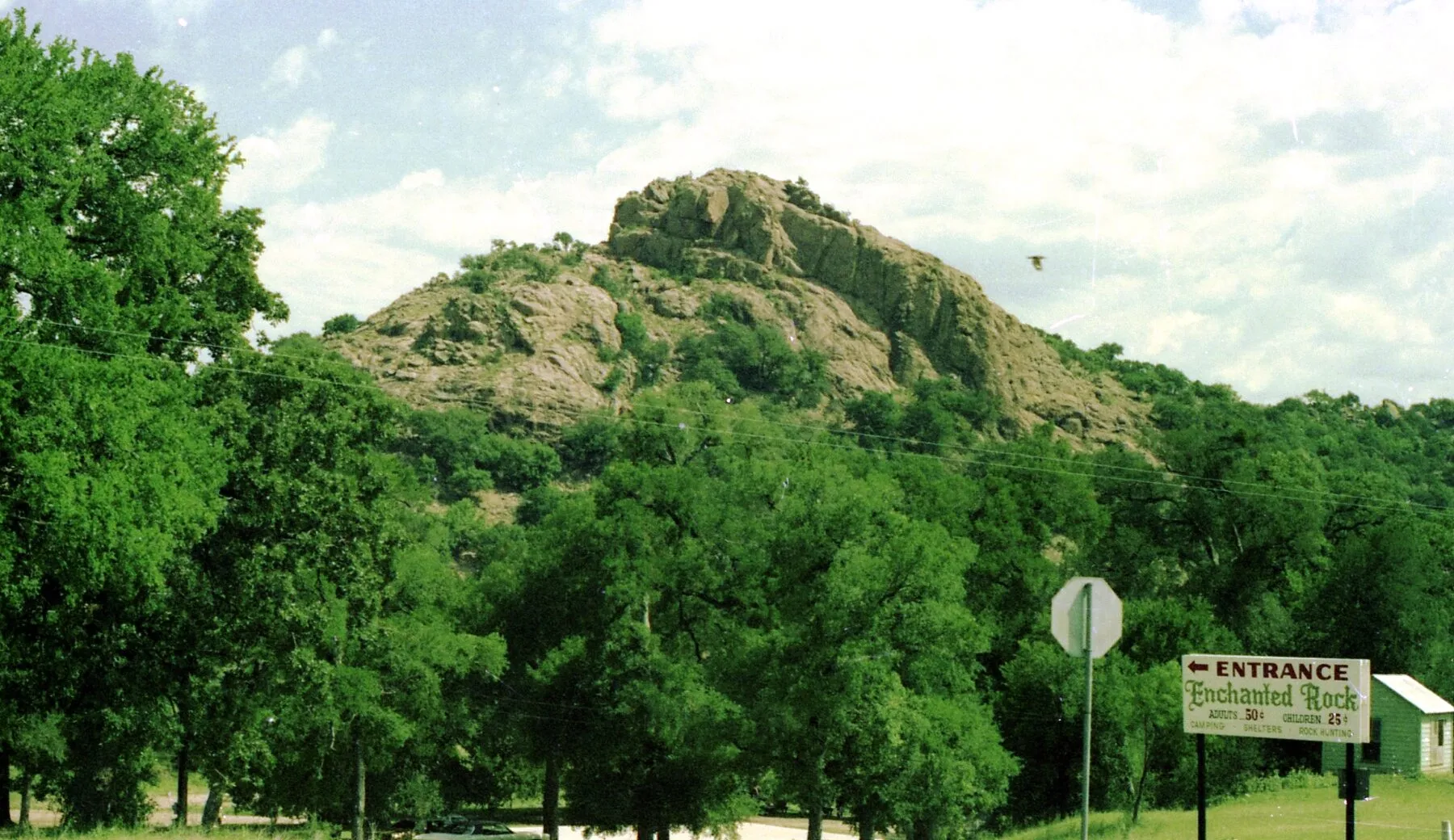 Enchanted Rock's rounded pink granite dome rising beneath a blue sky