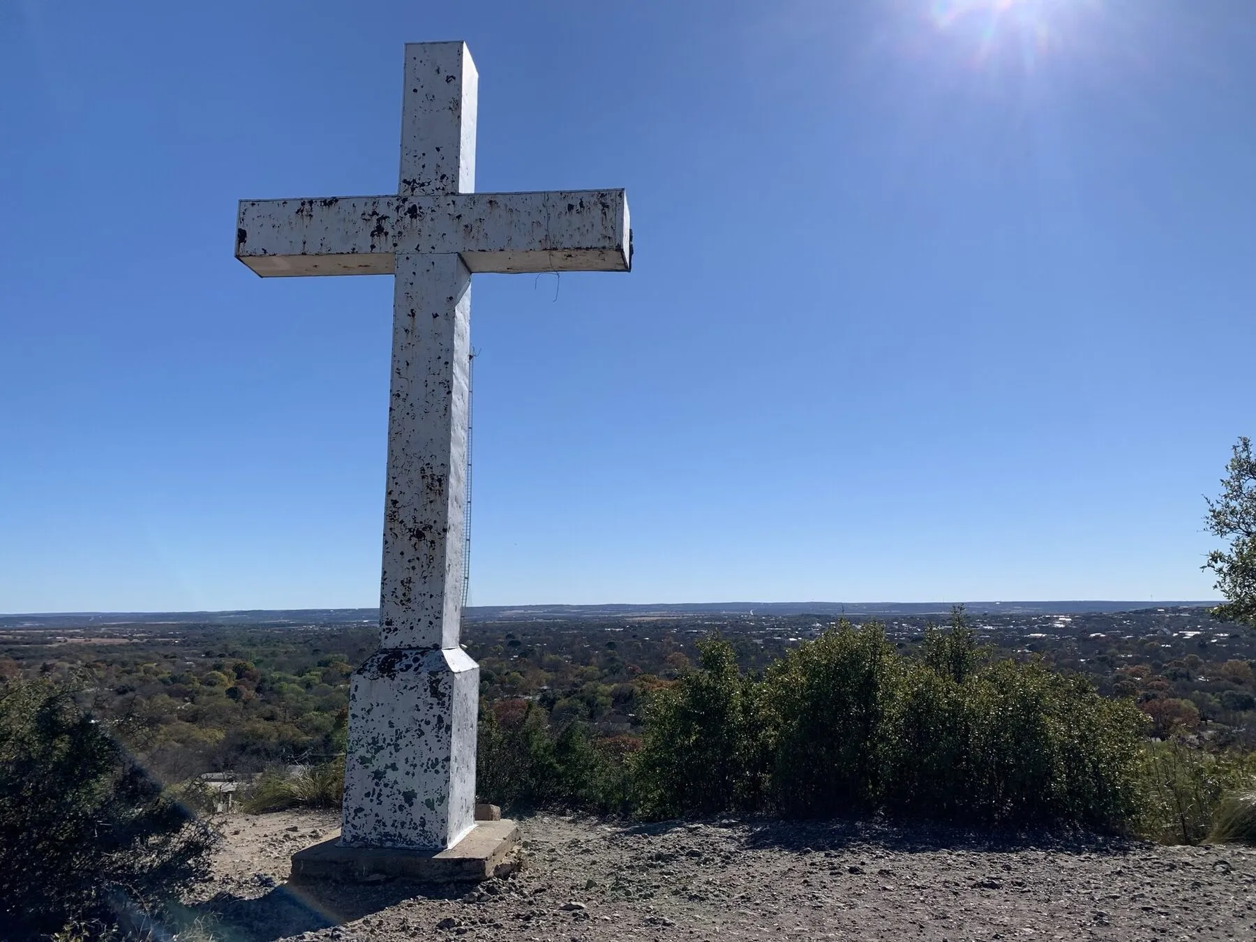 A large cross on a wooded hill above Fredericksburg