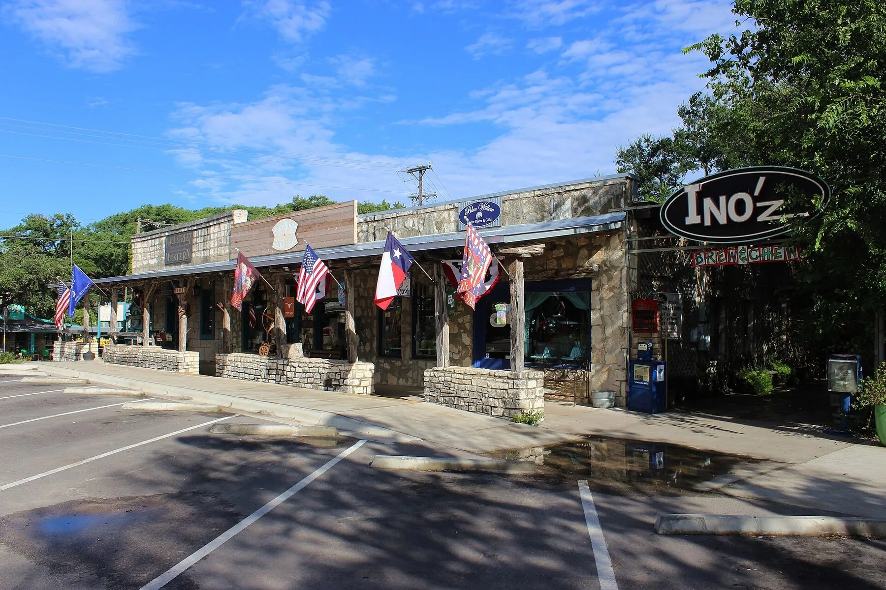 Small shops and parked cars along a street in downtown Wimberley