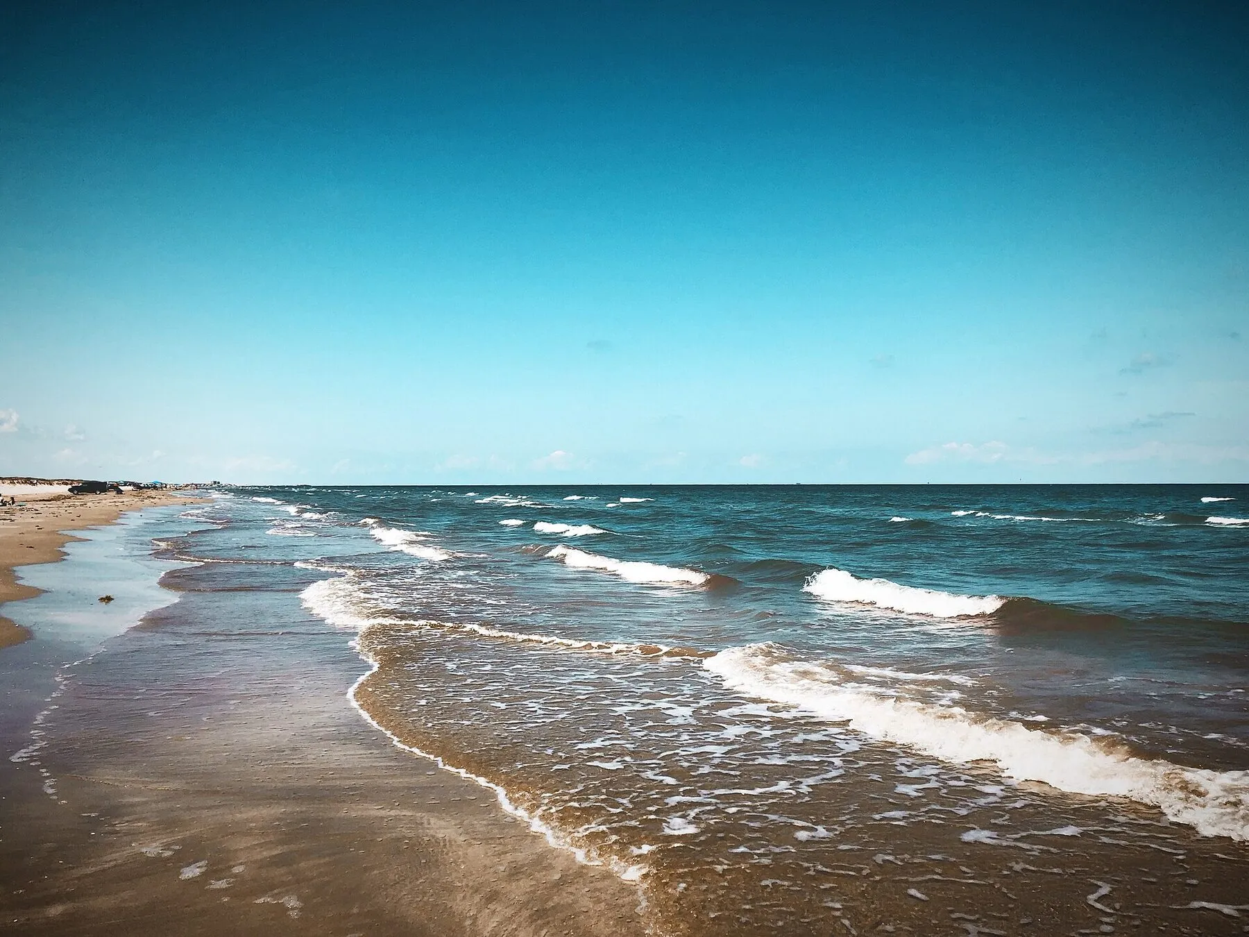 Sand, surf, and low dunes along the beach at Mustang Island State Park
